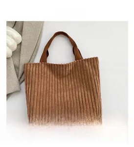 Detailed texture of brown corduroy tote bag with fashion leather patch logo