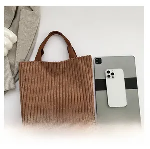 Detail of brown corduroy tote bag showing soft texture and Fashion Bags leather label