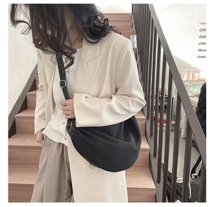 Close-up of a black crescent hobo bag made of durable nylon with adjustable shoulder strap