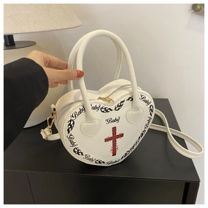 White heart-shaped PU leather handbag with black baby print and red cross details