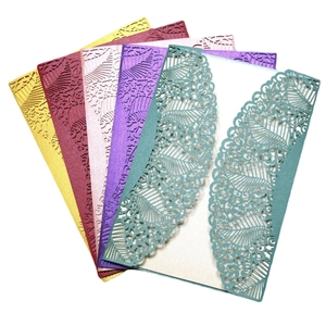 Laser-cut wedding invitation covers in various colors with elegant leaf and vine patterns