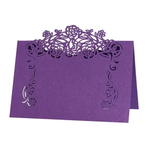 Deep purple laser cut place card with intricate floral and vine patterns for wedding tables
