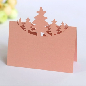 Laser-cut pink 3D Christmas tree place card with minimalist silhouette for table seating