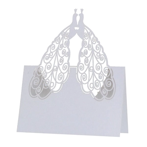 Elegant white laser-cut place card with peacock bird design for wedding table name settings