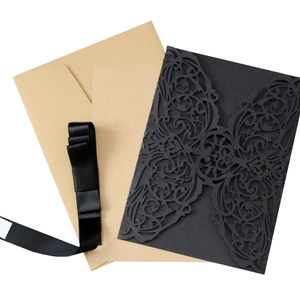 Elegant laser cut black invitation card set with kraft envelopes and a satin ribbon
