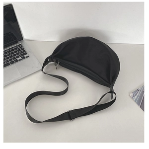 Close-up of crescent shoulder bag featuring durable nylon fabric and silver metal zipper