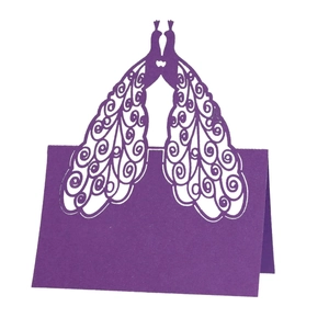 Elegant purple laser-cut peacock place card with intricate hollow design for weddings