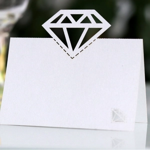 Elegant white laser-cut diamond-shaped place cards for wedding or banquet table settings