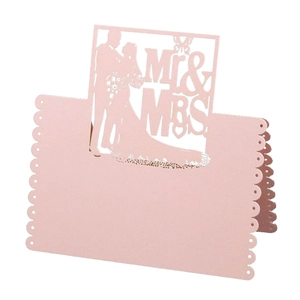 Pink laser-cut Mr & Mrs wedding place cards with heart silhouettes and dot details