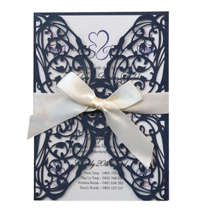 Navy blue laser cut wedding invitation with cream ribbon bow and S&S logo detail