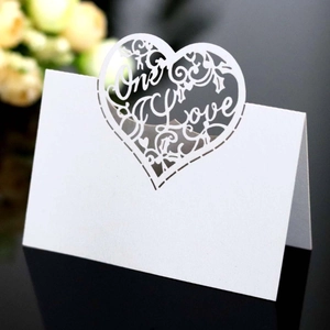 White laser-cut heart place card with One Love text for wedding table decor