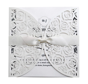 Elegant pearl white laser cut wedding invitation with rose pattern and satin ribbon bow