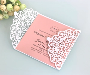 Elegant laser cut wedding invitation with white floral lace sleeve and pink inner card