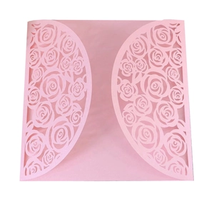 Detail of pink laser-cut rose pattern on elegant wedding invitation card envelope