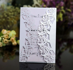 White LOVE laser-cut wedding invitation with pearl paper and a pink inner card