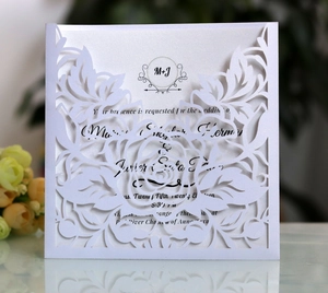 Detailed laser-cut floral wedding invitation with pearl white finish and elegant paper insert