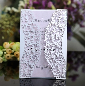 Elegant laser-cut lace invitation with white vine cover and light purple inner card