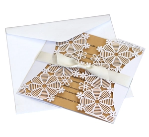 Elegant white laser-cut snowflake wedding invitation set with ribbon and kraft insert