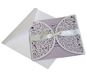 Laser cut white floral wedding invitation set with lavender insert and white ribbon
