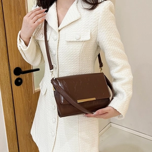 Brown vintage faux leather crossbody bag with gold metal trim and adjustable strap