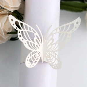Detailed macro view of laser-cut butterfly paper napkin ring for elegant wedding decor