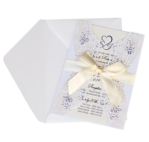 Elegant white laser-cut floral lace wedding invitation set with cream inner card and beige ribbon