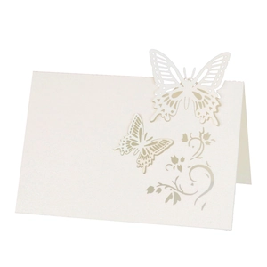 Elegant white laser-cut butterfly place cards made of premium pearlescent paper