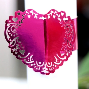 Pink heart-shaped napkin rings with laser-cut lace edge for wedding table decor