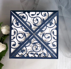 Detail of laser-cut navy floral wedding invitation with elegant white inner card