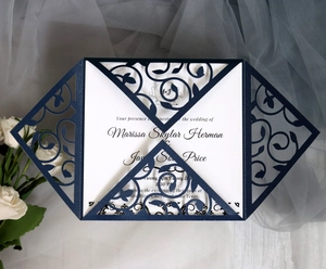 Detail of laser-cut navy blue glitter invitation cover with elegant floral vine patterns