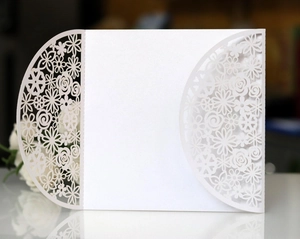 Elegant white laser-cut hollow floral wedding invitation card set in pearlescent paper
