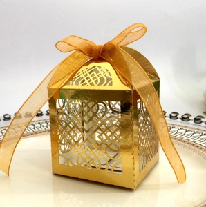 Macro detail of laser-cut heart pattern on golden gift box with elegant ribbon bow