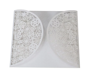 Detailed laser-cut floral pattern on white wedding invitation cardstock