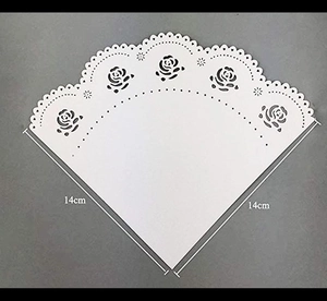 Macro shot of 14cm white lace paper doily with elegant rose cutout patterns