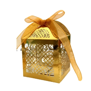 Exquisite laser-cut gold gift box with heart patterns and elegant organza ribbon bow