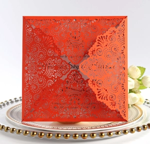Detail of laser-cut red invitation card with intricate mandala floral patterns