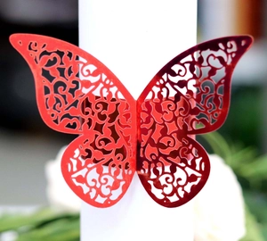 Laser-cut butterfly napkin ring in metallic red finish with intricate镂空 design