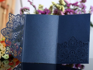 Detailed laser-cut navy blue glitter invitation cover with elegant lace hollow patterns