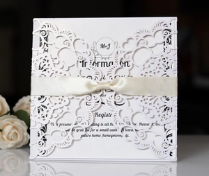 Detail van lasergesneden uitnodiging met elegant lint en parelmoer papier