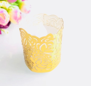 Close-up of golden laser-cut paper tea light holder with elegant floral rose pattern