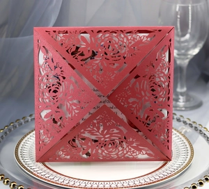 Elegant laser-cut burgundy wedding invitation set with rose patterns and white insert card