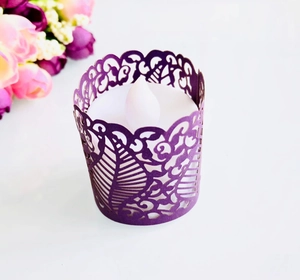 Detail showing deep purple laser-cut paper holder with intricate scrollwork for LED tea lights