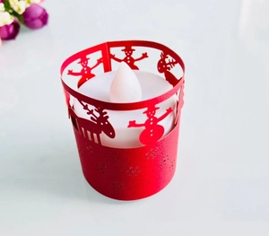 Close-up of laser-cut reindeer and snowman paper lampshade with LED tea light