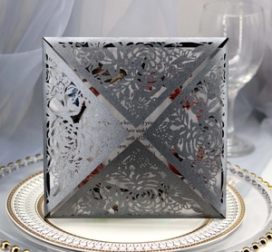 Elegant laser-cut silver wedding invitation card with rose pattern and pearlescent finish