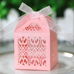 Pink laser-cut floral candy box with white ribbon bow for wedding gift packaging