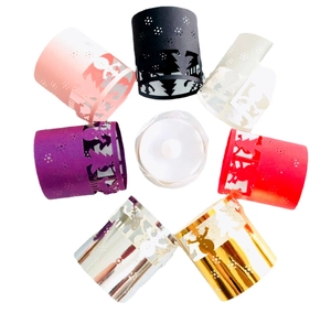 Set of 7 colorful laser-cut Christmas tea light wraps with LED candles and festive patterns