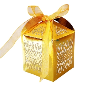 Golden laser-cut candy gift box with European vine patterns and yellow ribbon bow