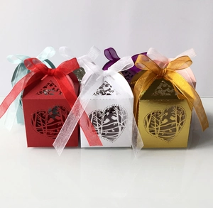 Detailed laser-cut heart and bird pattern on colorful candy boxes with ribbon bows