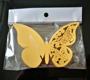 Detail of yellow glitter butterfly wall stickers with intricate laser-cut hollow patterns
