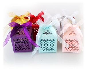Laser cut hollow candy boxes in six colors with ribbon bows for wedding party favors